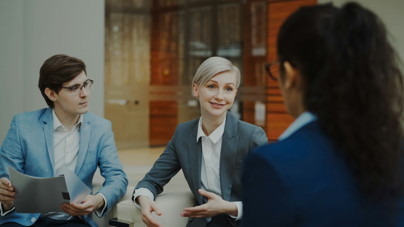 People discussing documents during a business meeting.